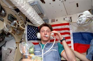 Astronaut Michael Foale uses the Russian short-wave radio to communicate with the Earth from the Base Block module.